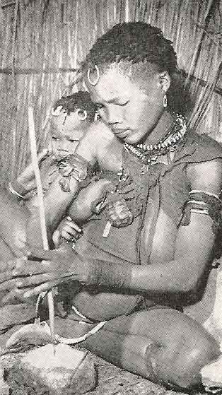 Bushman Woman Drilling Hole in an Ostrich Eggshell Bead - webAfriqa - SemanticAfrica Bushman Woman Drilling Hole in an Ostrich Eggshell Bead